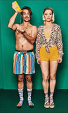 Two people wearing colorful clothing against a green background Xpooos sokkar - bestu sokkarnir - sætir sokkar
